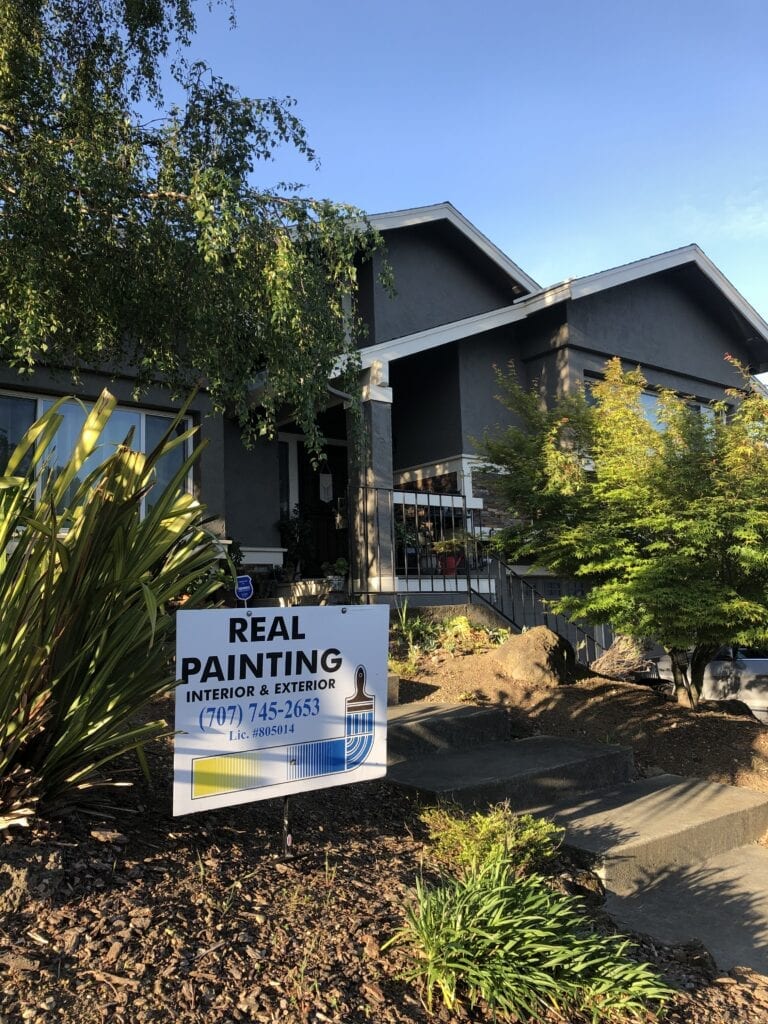 House exterior with Real Painting sign